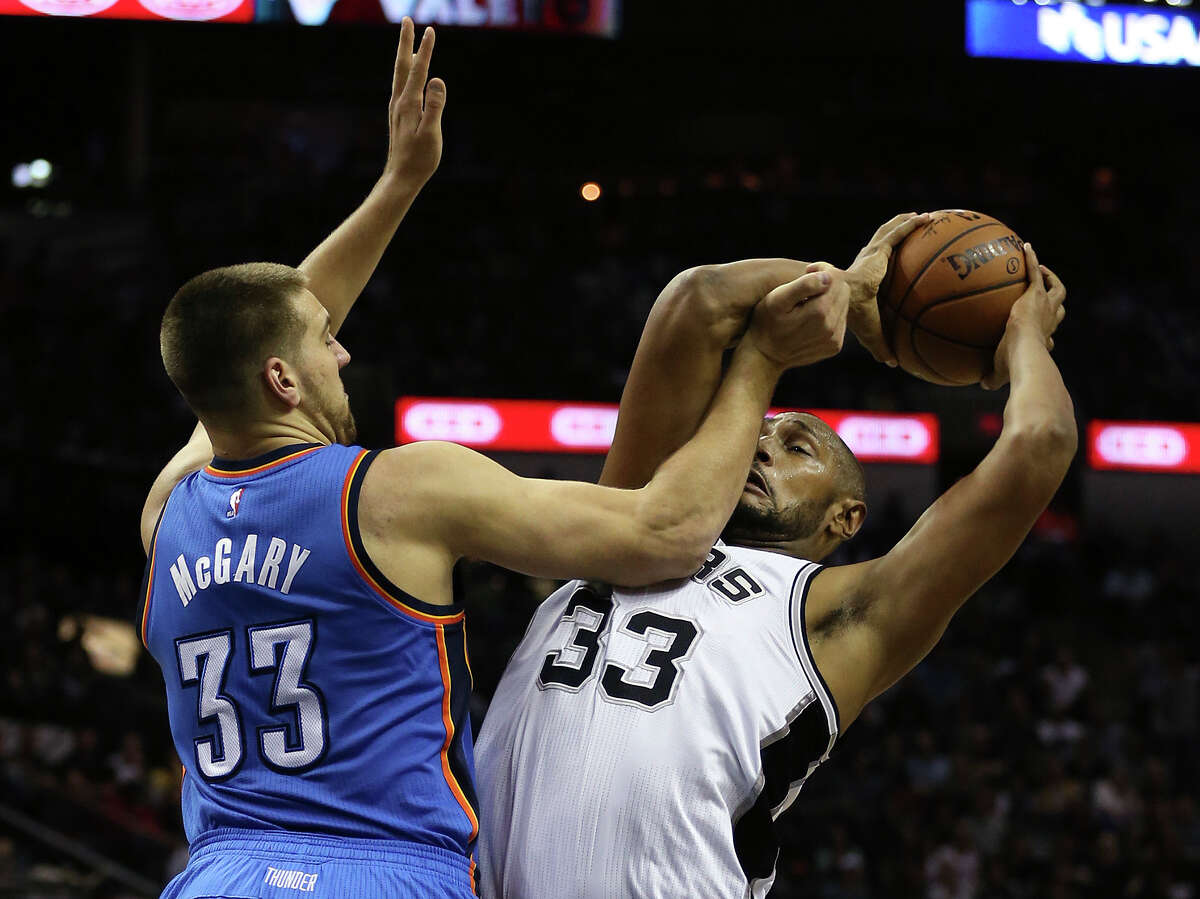San Antonio Spurs' Boris Diaw gets pressure from Oklahoma City Thunder's Mitch McGary during the first half at the AT&T Center, Wednesday, March 25, 2015.