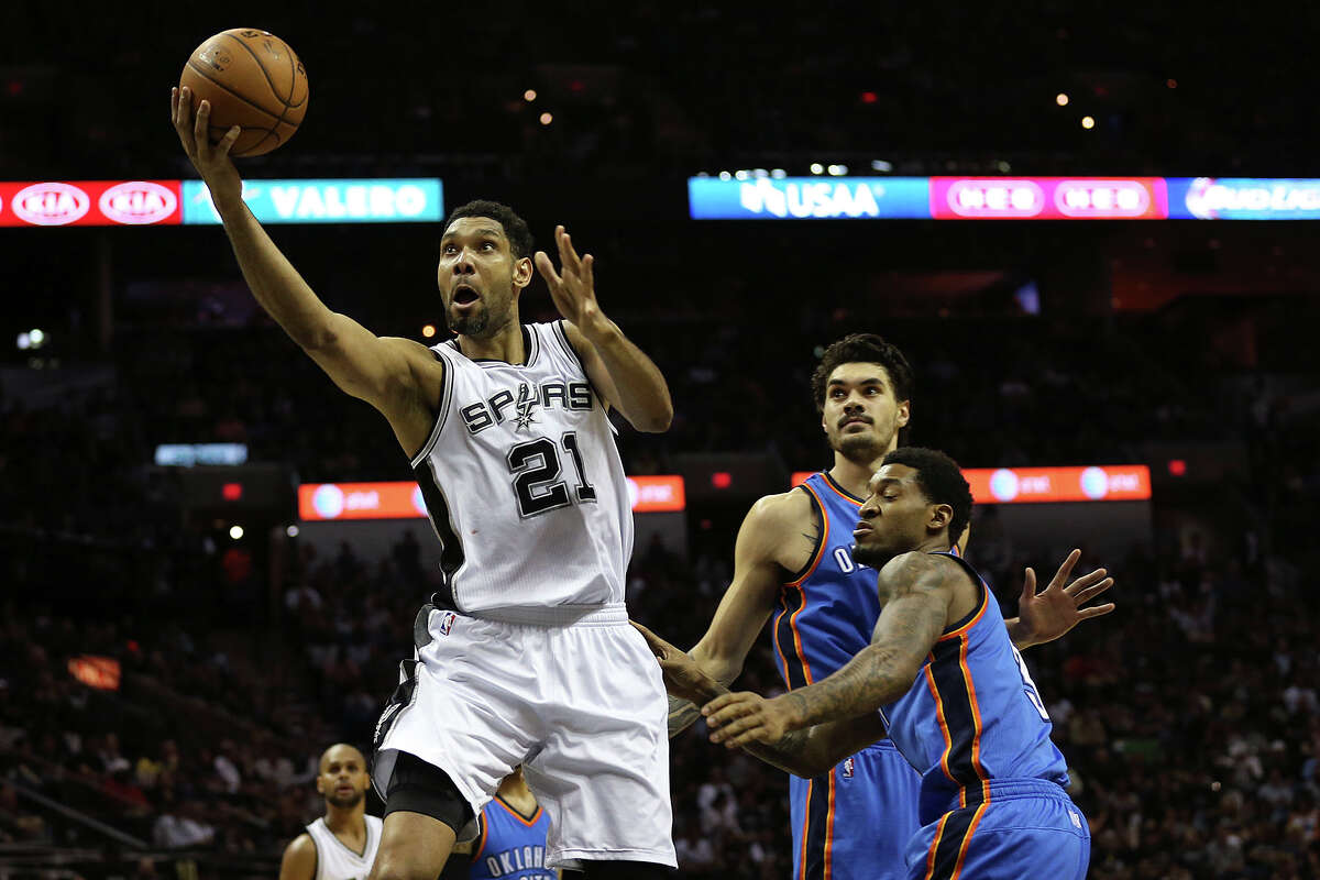 San Antonio Spurs' Tim Duncan gets past Oklahoma City Thunder's Steven Adams, center, and Perry Jones during the first half at the AT&T Center, Wednesday, March 25, 2015.