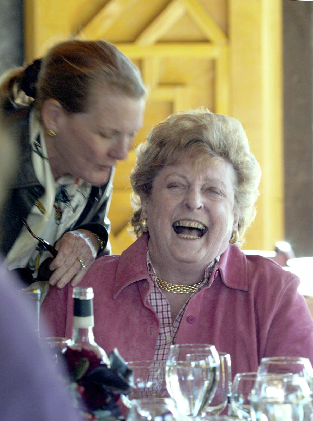 Nan McEvoy enjoyed a light moment with a friend at her Petaluma olive ranch. By Brant Ward/Chronicle