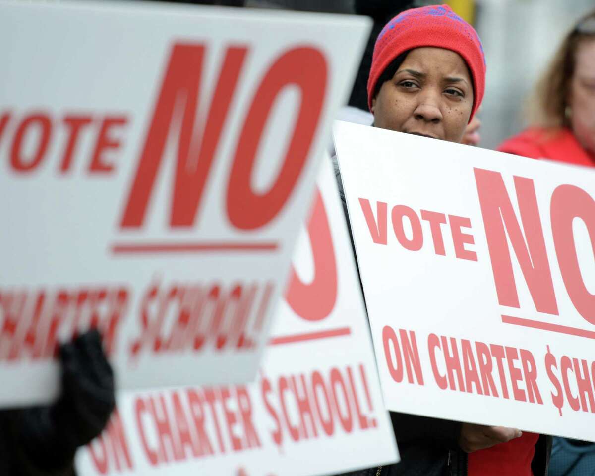 Twana Johnson, a Bridgeport parent, demonstrates Thursday, Mar. 26, 2015, outside Park City Prep charter middle school in Bridgeport with other parents opposed to the spread of charter schools in the city.