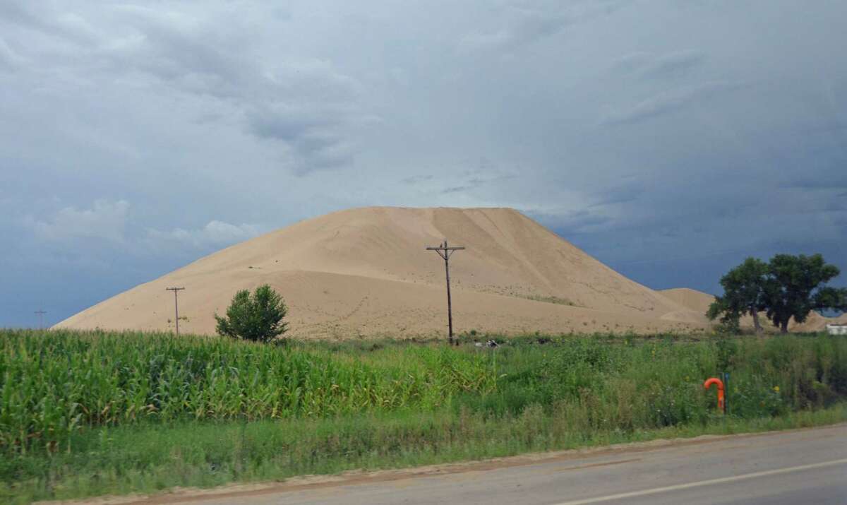 Hydraulic fracturing requires mountains of sand like this ﻿﻿in Colorado. ﻿ Some say pumping more sand can bring up more oil.