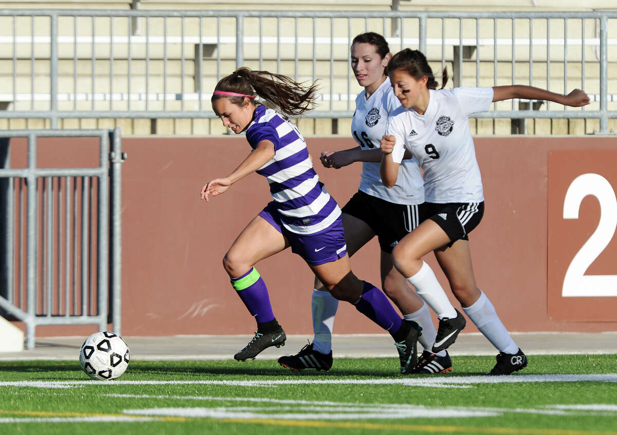 Port Neches-Groves' Hannah Higgins, No. 6, pulls away from Galena Park's Merilyn Duarte, No. 16, and Trinity Herrera, No. 9, as she pushes the ball up the field Friday. The Port Neches-Groves Indian girls soccer team played against Galena Park Yellowjackets at the Carrol A. "Butch" Thomas Educational Support Center on Friday. Photo taken Friday 3/27/15 Jake Daniels/The Enterprise