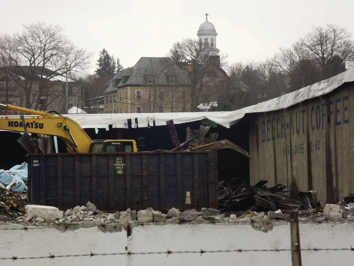 Demolition work continues this month at the former Beech-Nut plant in Canajoharie, where a hoped-for redevelopment of site is stymied by unpaid property taxes, problems with asbestos removal, and unpaid bills.