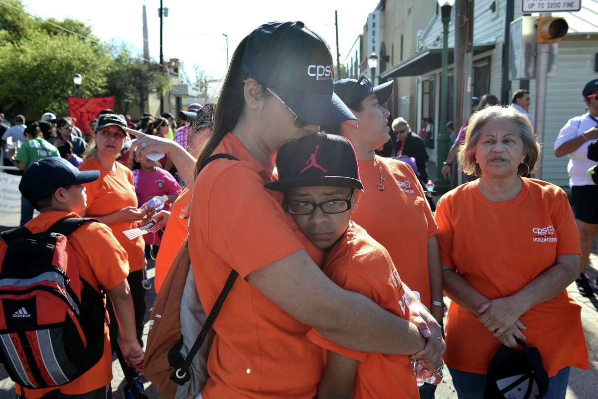 Melinda Solis hugs her son Nathaniel Soto during the annual César Chávez March for Justice from the West Side to the Alamo.
