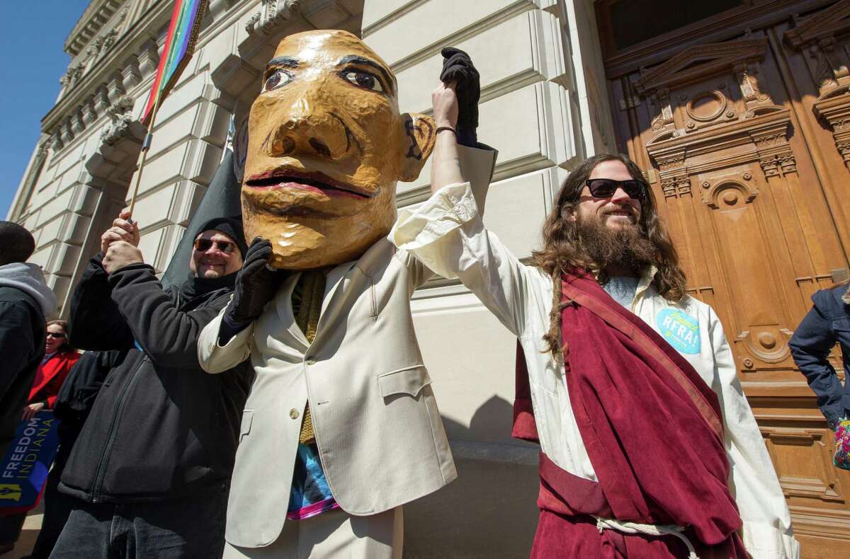 A pair of impersonators take part in Saturday's protest against Indiana's Religious Freedom Restoration Act. The protesters say the new law makes religious bigotry toward gays and lesbians legal.