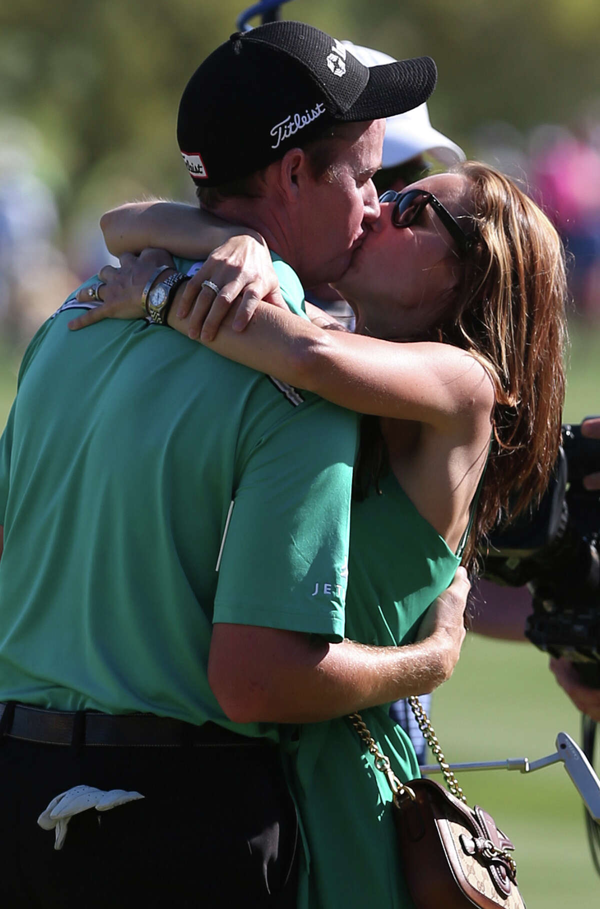 Jimmy Walker of Boerne, kisses his wife, Erin, after winning the Valero Texas Open at TPC San Antonio, Sunday, March 209, 2015. Walker shot an 11-under to take the $1.1 million purse. Coming at second with an 7-under was Jordan Spieth of Dallas and Billy Horschel came in third at 4-under.