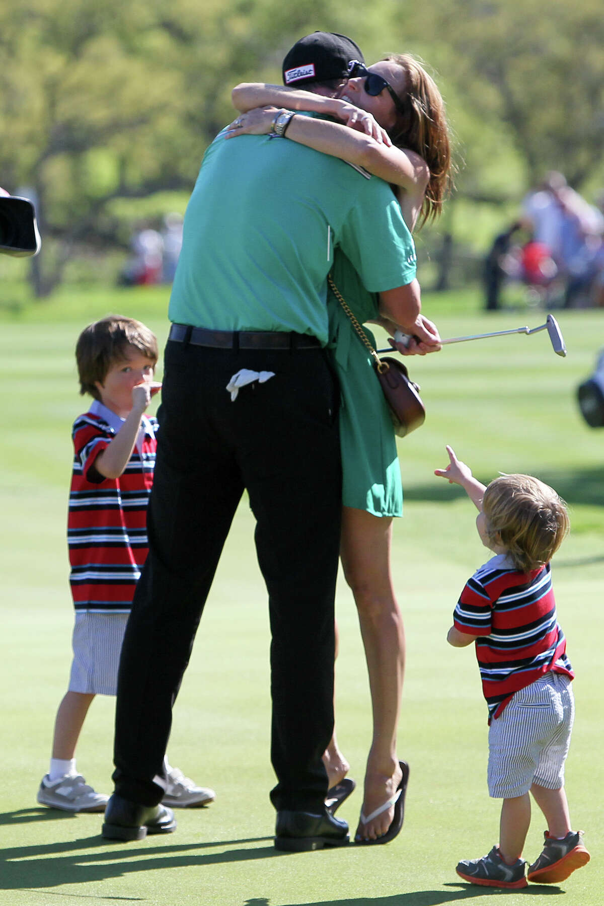 Jimmy Walker of Boerne, TX is greeted by his wife, Erin and sons Mclain (left), 4, and Beckett, 2, on the 18th hole after winning the Valero Texas Open at TPC San Antonio on Sunday, March 29, 2015. MARVIN PFEIFFER/ mpfeiffer@express-news.net