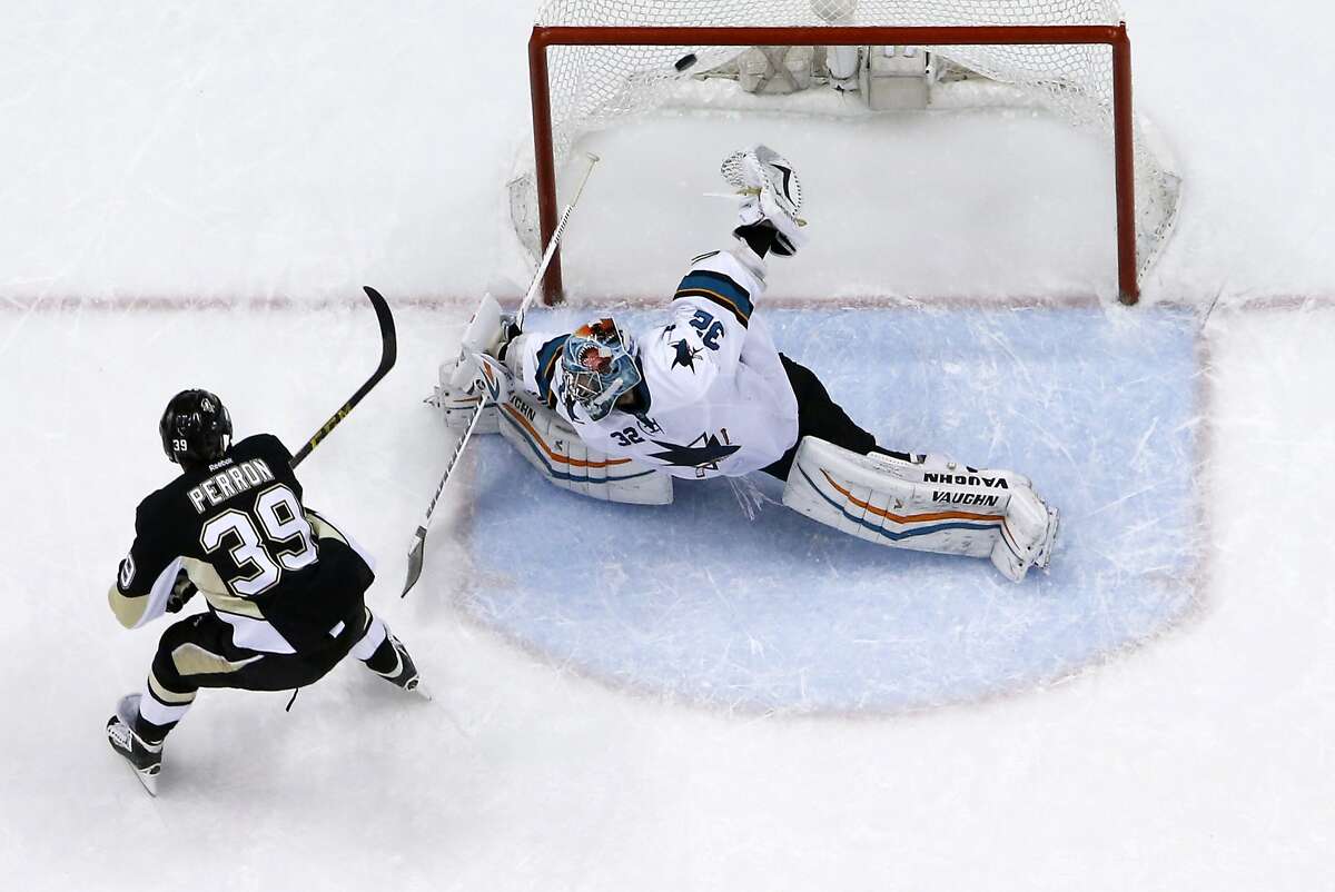 Pittsburgh Penguins' David Perron (39) puts the puck over San Jose Sharks goalie Alex Stalock (32) for a shootout goal during an NHL hockey game in Pittsburgh Sunday, March 29, 2015. The Penguins won the game 3-2. (AP Photo/Gene J. Puskar)