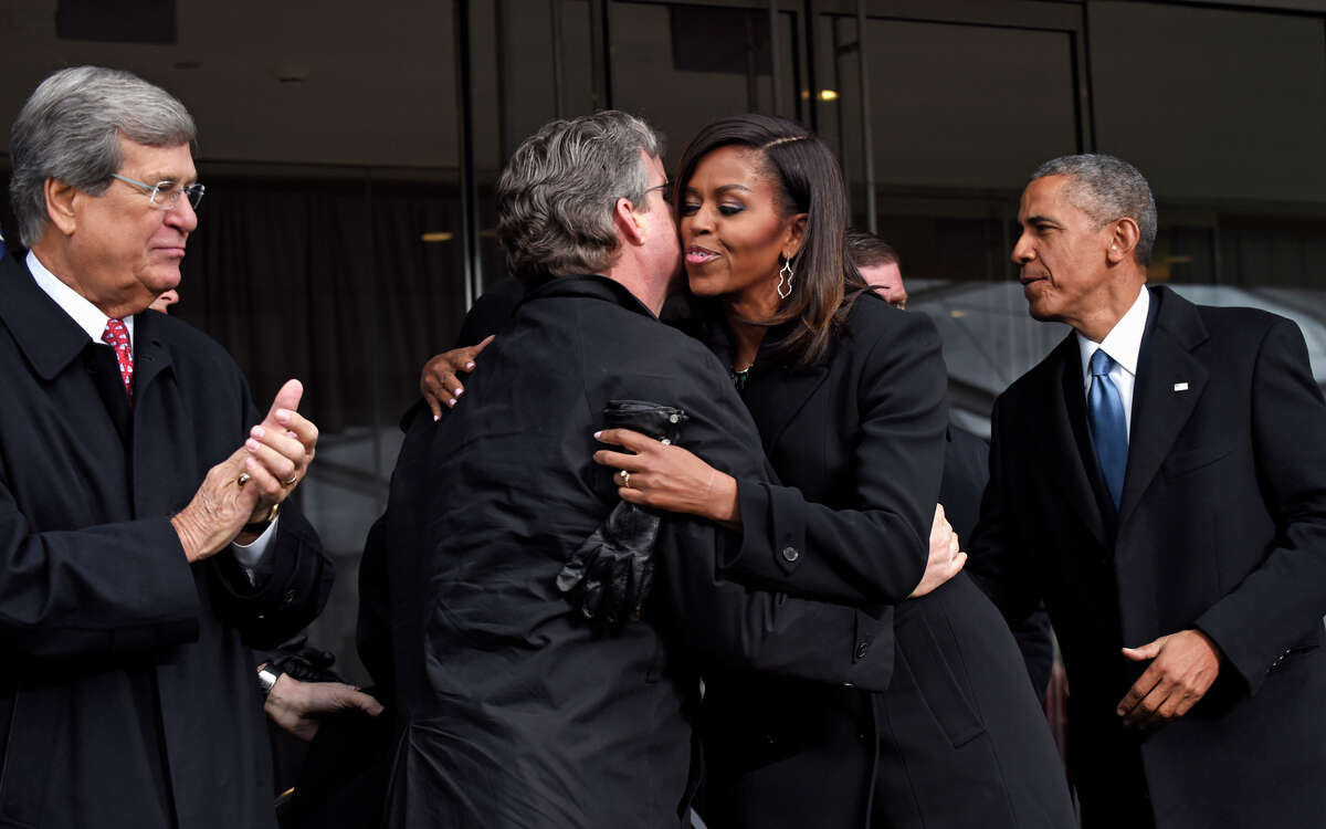 Michelle Obama hugs Ted Kennedy Jr. alongside former Sen. Trent Lott (left) and President Obama.
