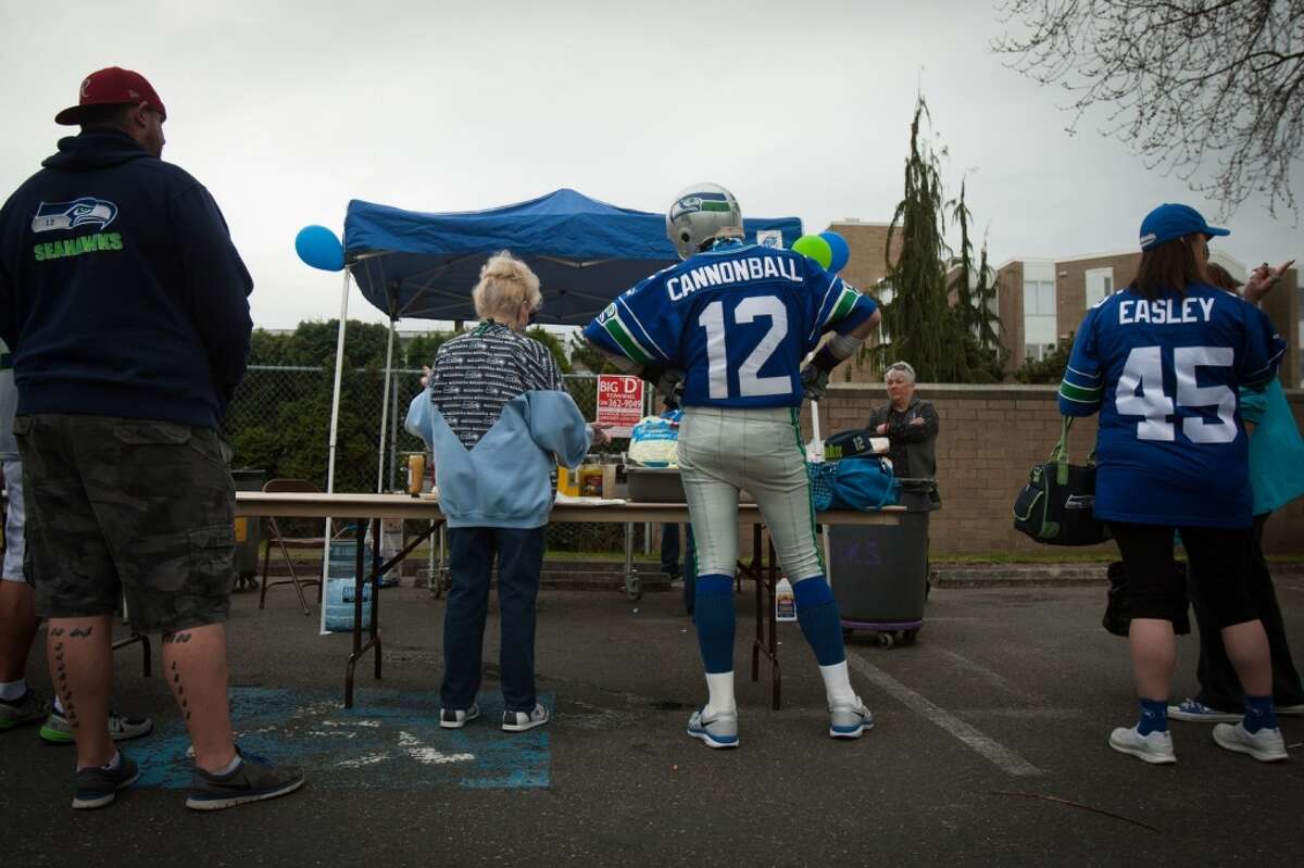 A Seahawks fan known by his fan name, Cannonball, waits in line for food during the inaugural 12s Rally for 12s, a Seahawks rally and fundraiser at the Ballard Elks on Sunday March 29, 2015. Fans gathered to raise money for local charities and help 12 fan John Bachner, who was paralyzed last September in a car accident. (Daniella Beccaria, seattlepi.com)