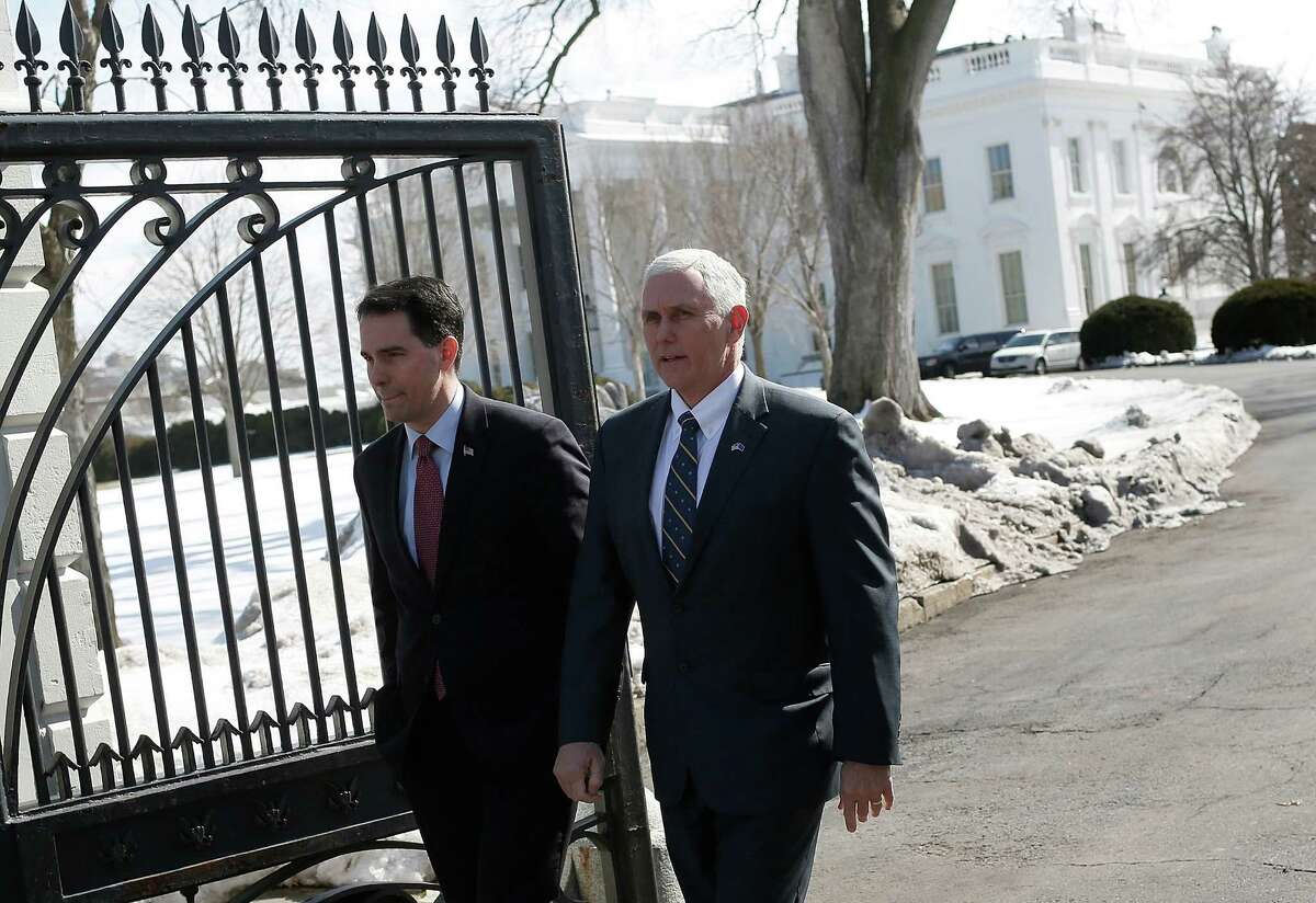 WASHINGTON, DC - FEBRUARY 23: Wisconsin Gov. Scott Walker (L) (R-WI) and Indiana Gov. Mike Pence (R) (R-IN) depart the White House after U.S. President Barack Obama addressed members of the National Governors Association February 23, 2015 in Washington, DC. Obama's meeting with the nation's governors comes just days before the Department of Homeland Security's $40 billion budget is set to expire. (Photo by Win McNamee/Getty Images)