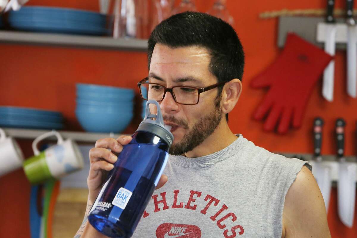 Justin Lagana-Jackson, Oakland resident in the Laurel district, sips from a water bottle after filling it from the tap at the sink in his kitchen as he poses for a portrait at his home on Monday, March 30, 2015 in Oakland, California. Lagana-Jackson noticed a different taste in his water after drinking from a water bottle filled from the garden hose while working in his yard on Sunday.