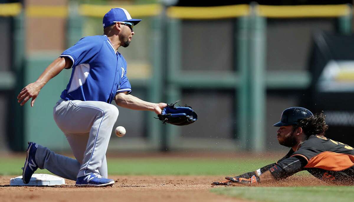 Giants shortstop Brandon Crawford steals second base in a Cactus League game last month as the Royals’ Omar Infante misses the ball.
