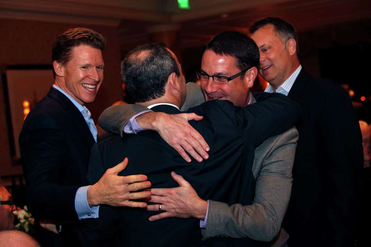 Evan Marwell (second from left), CEO and founder of EducationSuperHighway, is hugged by James Willcox, CEO of Aspire Public Schools after Marwell is named the San Francisco Chronicle's Visionary of the Year at the Fairmont Hotel, Tuesday, March 31, 2015, in San Francisco, Calif.