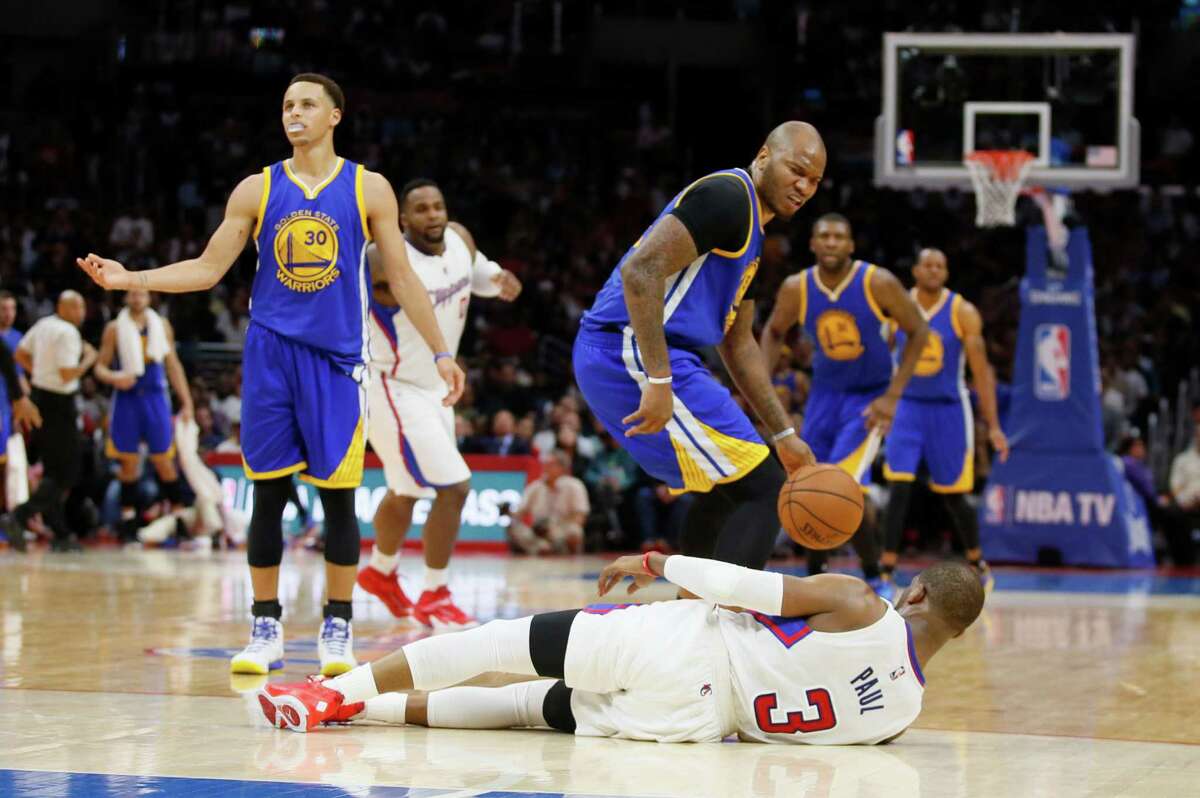Golden State Warriors' Marreese Speights, center, is called for a personal foul and technical foul while looking down at Los Angeles Clippers' Chris Paul, bottom, after colliding with him as Paul dribbled the ball down the court during the second half of an NBA basketball game, Tuesday, March 31, 2015, in Los Angeles. Also looking on are Golden State Warriors' Stephen Curry, left, Los Angeles Clippers' Glen Davis, second left, and Warriors' Festus Ezeli, right. (AP Photo/Danny Moloshok)