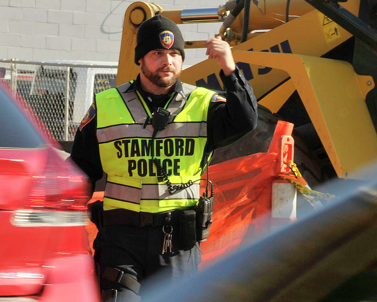 Stamford Police Officer directing traffic at the construction site at Myrtle Avenue and East Main Street in Stamford, Conn., on Monday, Nov. 10, 2014.