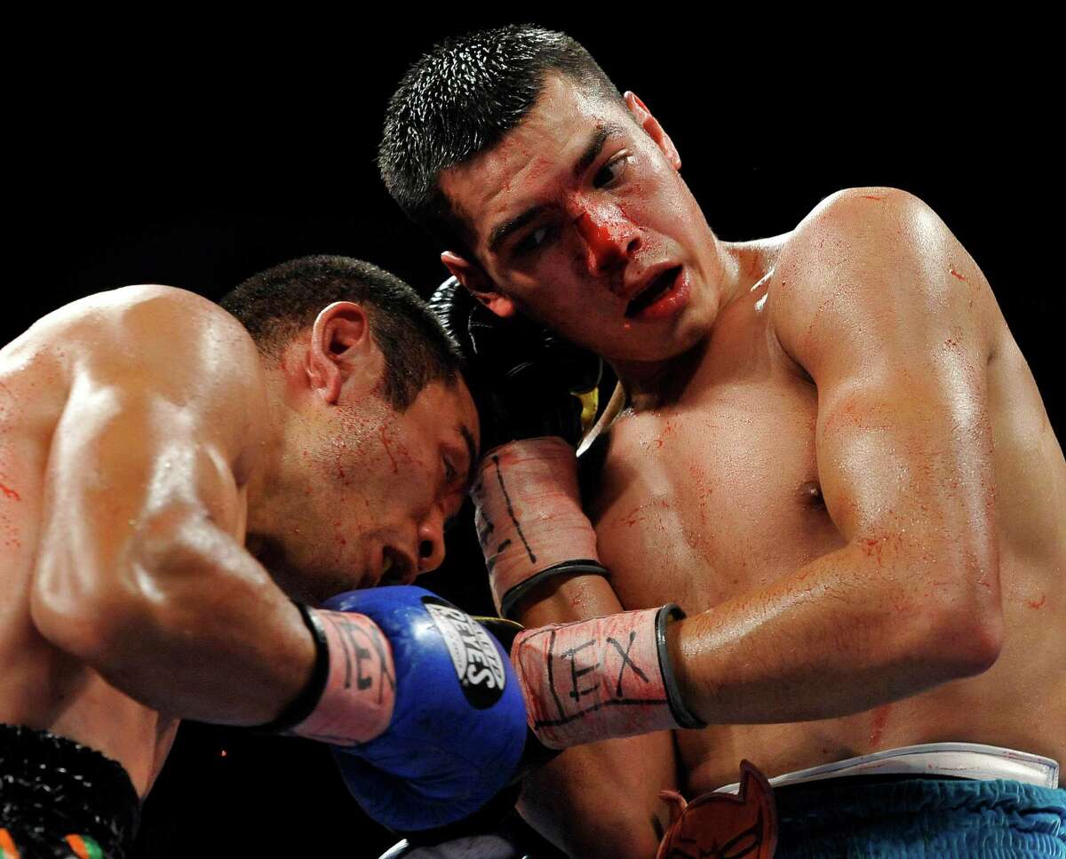 Omar Figueroa, Jr., right, and Nihito Arakawa, of Japan, exchange punches during a lightweight title boxing match on July 27, 2013, in San Antonio. Figueroa won by decision after 12 rounds.
