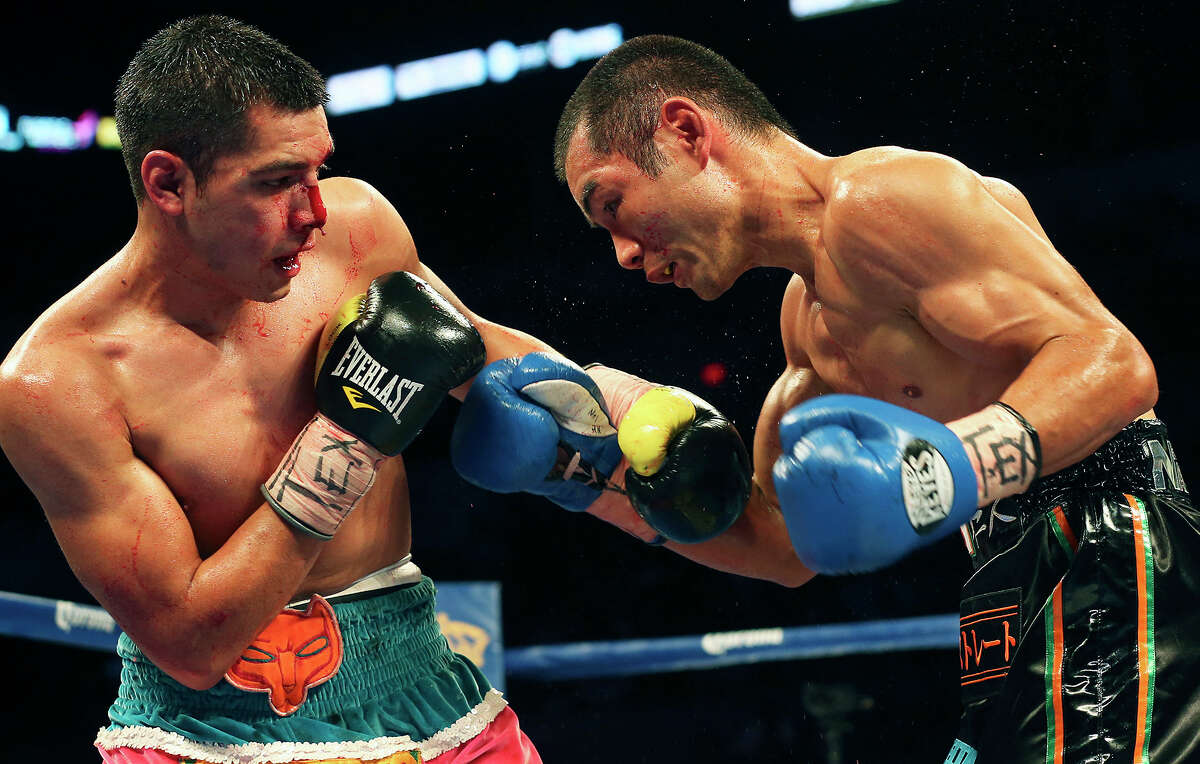 Omar Figueroa (left) battles Nihito Arakawa during the Knockout Kings II boxing card at the AT&T Center on July 27, 2013.