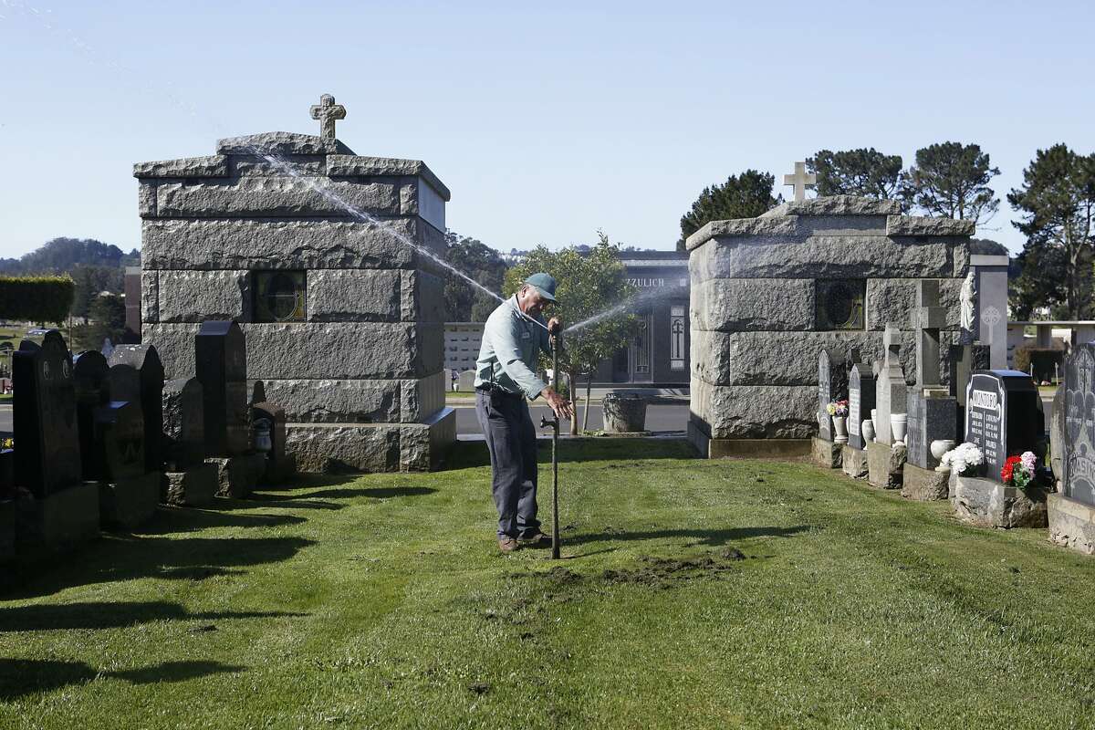 Groundskeeper Filiberto Garcia adjusts a sprinkler in the Italian Cemetery in Colma, CA, on Thursday, April 2, 2015. Many cemeteries will have to adapt after California Governor Jerry Brown announced on Wednesday that water agencies in the state will be required to cut usage by 25 percent.