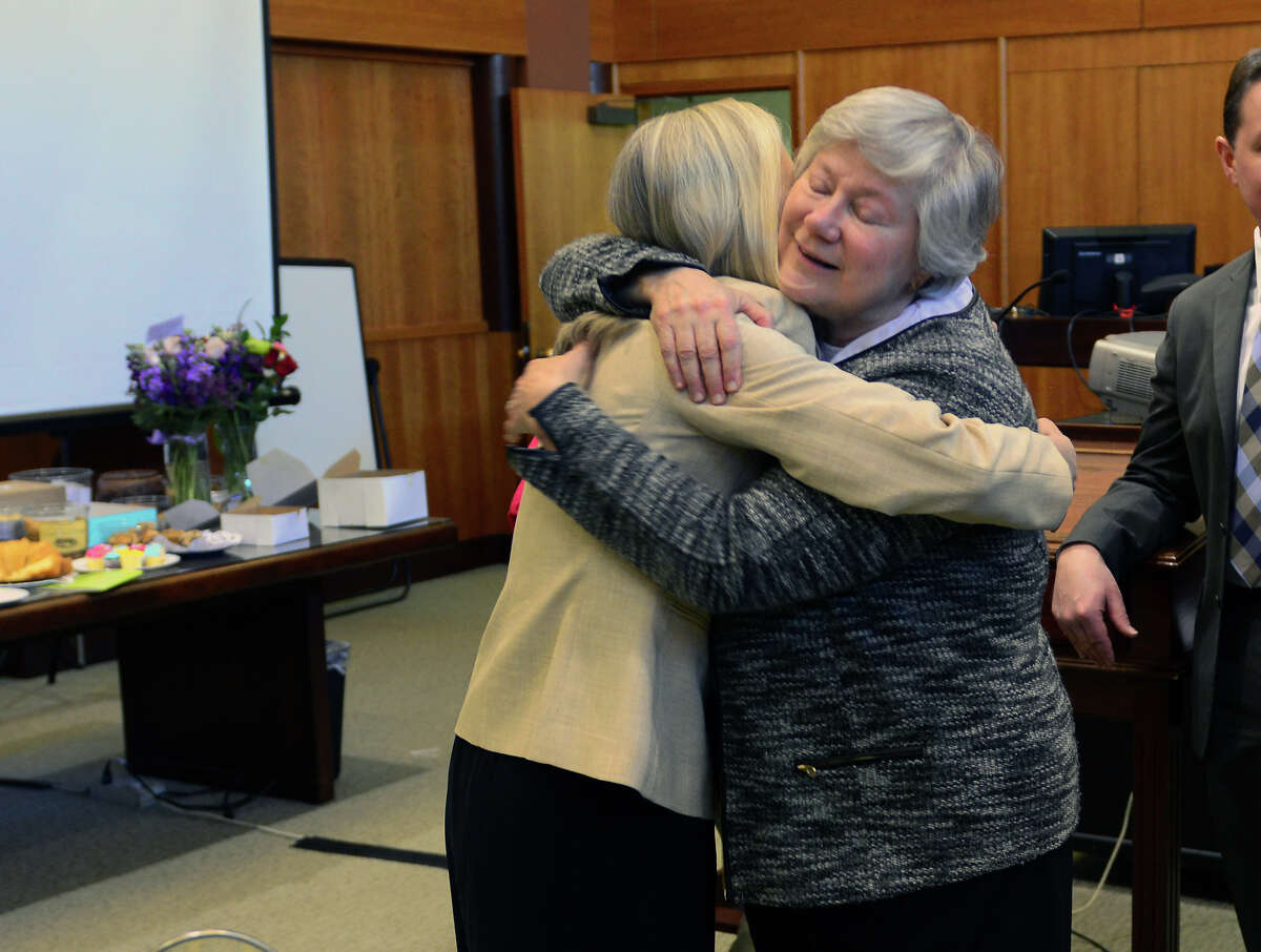 U.S. Magistrate Judge Holly Fitzsimmons, facing camera, hugs colleague and friend Superior Court Judge Barbara Jongbloed, during a retirement part for Fitzsimmons in her courtroom at Federal Courthouse on Lafayette Street in Bridgeport, Conn., on Thursday Apr. 2, 2015.