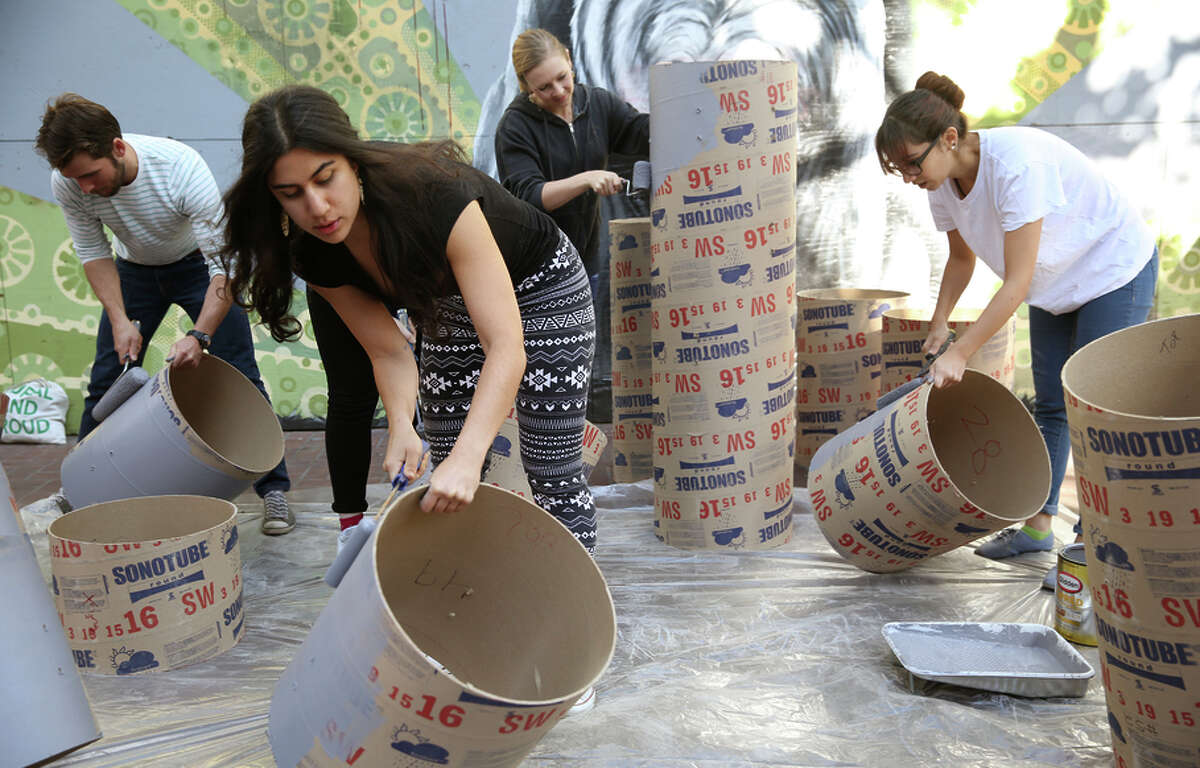 Matt Adams (left), Lily Nikzad (front), Cassiopeia McDonald and Katie Marazita create the installation “Show Box.”