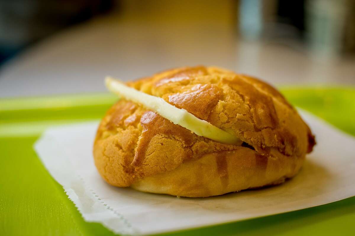 The pineapple bun at Pineapple King Bakery is rewarmed and served with a slab of cold butter.