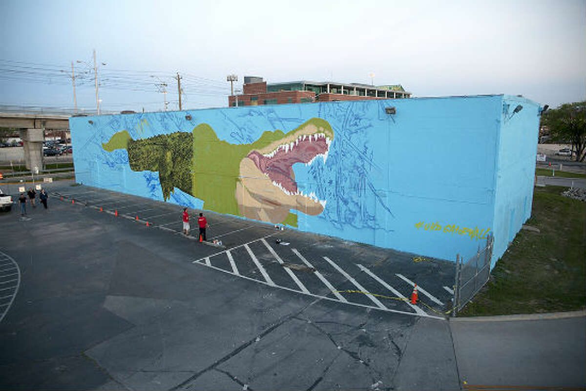 Houston-based French street artist Sebastien "Mr. D" Boileau is currently painting a large, intricate mural on the University of Houston-Downtown campus of the school’s mascot, Ed-U-Gator. The mural is coming to life on the north side of a storage facility, steps away from a student parking lot at Main Street and I-10.