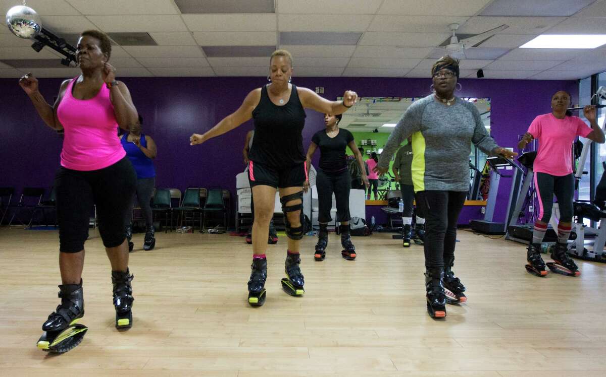 Members of Mia Trevillion's Groove Bounce Fun fitness class perform a workout with Kangoo jumping boots on Tuesday, March 17, 2015, in Houston. The boots provide a bouncy, low-impact workout.