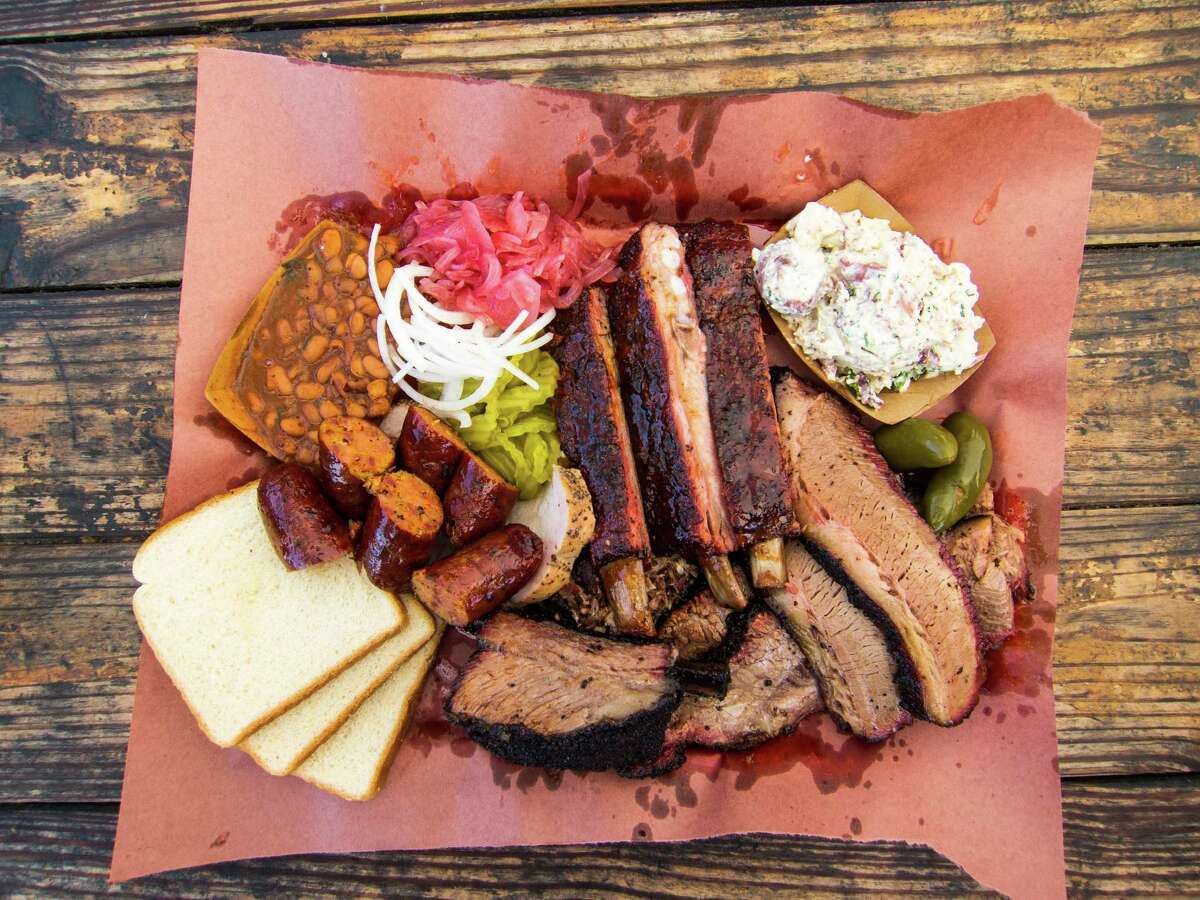 A spread of barbecue made by John Lewis at La Barbecue in Austin, above. Franklin Barbecue in Austin, left, is open Wednesdays-Sundays from 11 a.m. to 4 p.m. or until it runs out of food.