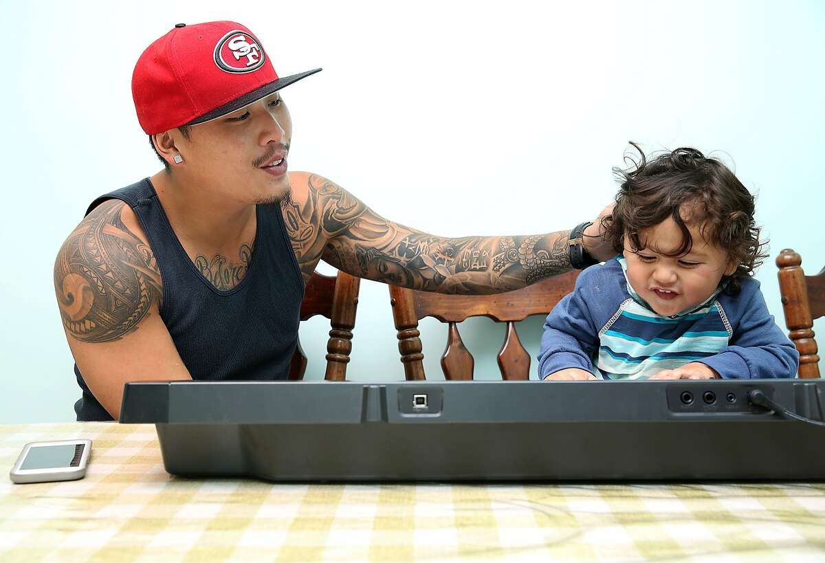 Kevin Yip playing with his 22 month old son, Dominic King Yip at his parents' home where he grew up in San Bruno, California, on Friday, April 3, 2015.