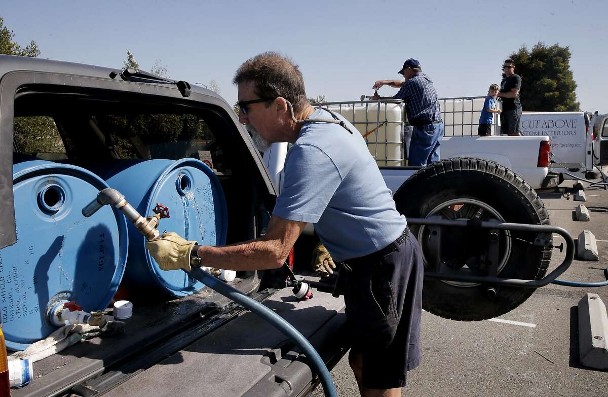 Steve London joins a line of vehicles as they fill their containers with recycled water at the Dublin San Ramon Services District Recycled Water Plant in Pleasanton, Calif., as seen on Fri. April 3, 2015.