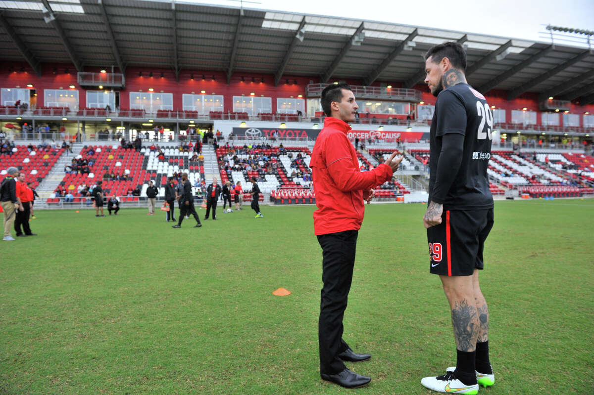 Scorpions coach Alen Marcina talks with player Eric Hassli before the 2015 spring season opener against the Tampa Bay Rowdies.