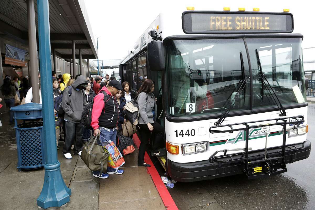 Passengers board an AC Transit shuttle at the Coliseum BART Station in Oakland on Sunday, April 5, 2015. A section of track between the Coliseum and Fruitvale stations will be closed on Sundays while crews replace aging tracks and ties. AC Transit is offering buses between the two stations during the closures.