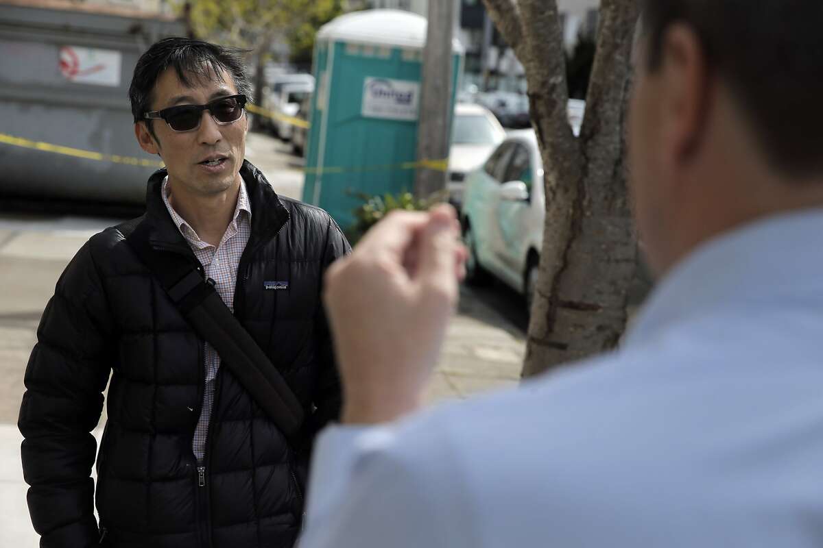 San Francisco Supervisor Eric Mar checked in with a neighbor who declined to be identified on Sunday, April 5, 2015 at the home in San Francisco , Calif. where a mummified body had been discovered the day before. Mar was looking for comments from neighbors on how the city could prevent the spread of vermin and spiders as the home is emptied and to provide services for mental health or senior care to stop such a thing from happening to other elders.