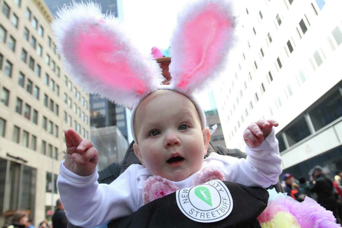Maelie Swanson held by her father Jeff Swanson participate in the Easter Parade along New York's Fifth Avenue on Sunday, April 5, 2015. (AP Photo/Tina Fineberg) ORG XMIT: NYTF103