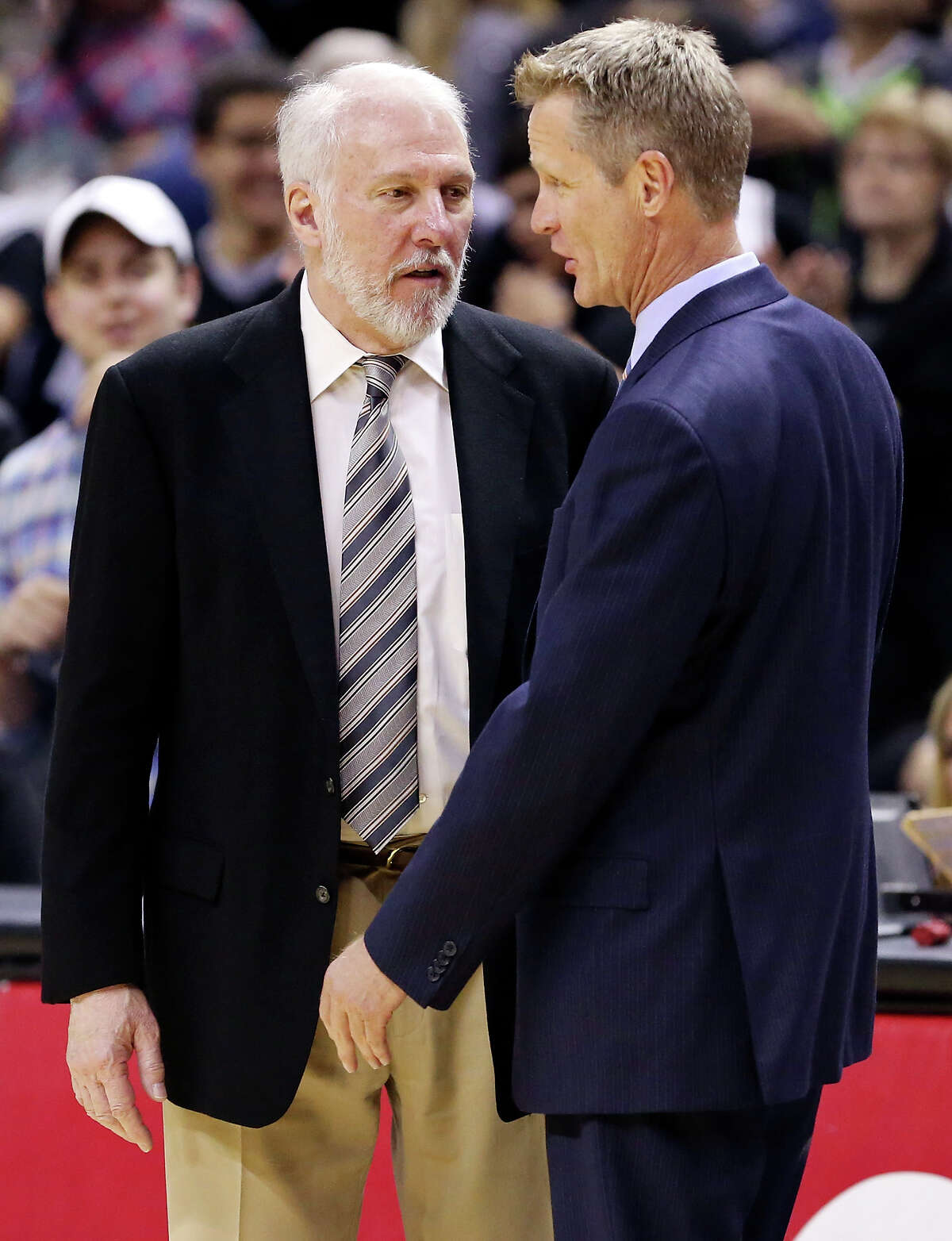 Spurs head coach Gregg Popovich (left) and Golden State Warriors head coach Steve Kerr talk after the game on April 5, 2015 at the AT&T Center.