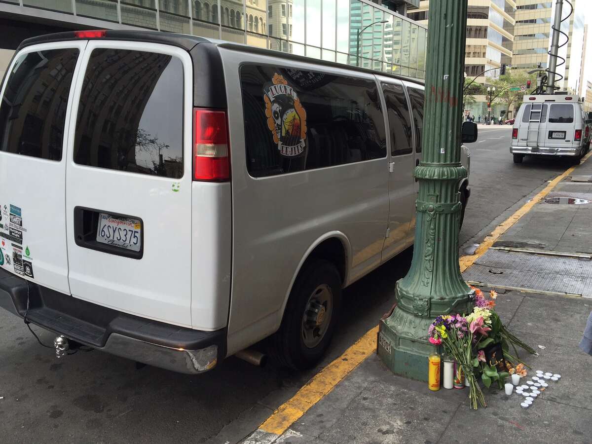 A makeshift memorial sits outside the van that musician Emiliano “Emilio” Nevarez was loading near 14th Street and Broadway in downtown Oakland when he was shot and killed on April 5, 2015.