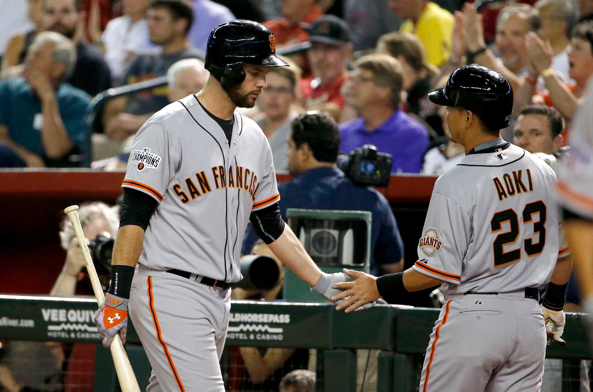 San Francisco Giants first baseman Brandon Belt, right, stands