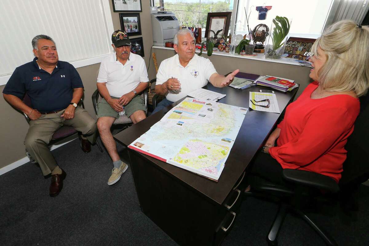 Tony Fuentes (from left), Lorenzo Rodriguez and Manuel Soto talk about their recent trip back to Vietnam with Janice Roznowski of Operation Comfort.