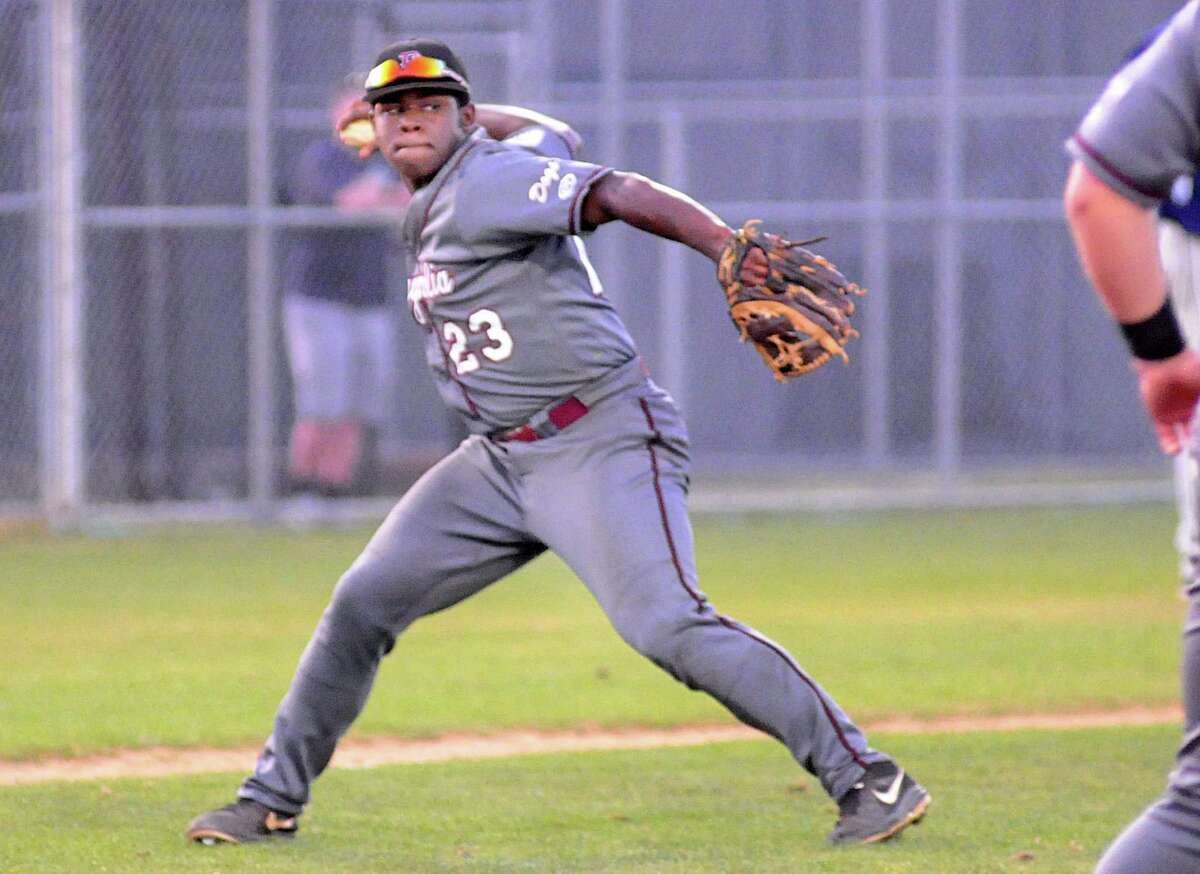 Magnolia third baseman Jarel McDade throws to first after fielding a bunt during the game at Tomball Memorial.