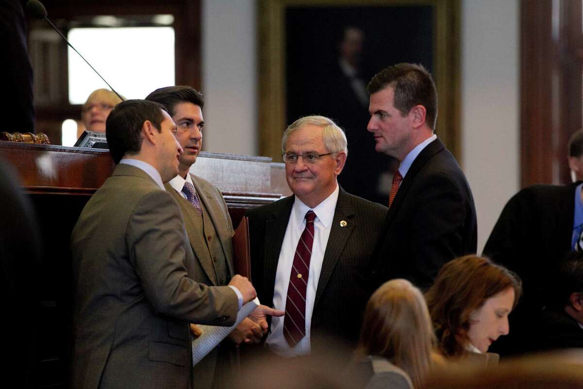From left, Rep. Trey Martinez Fischer, Rep. Eddie Rodriquez, Rep. Jimmie Don Aycock and Rep. Brandon Creighton speak near the dais on the House floor at the Capitol during debate on House Bill 5 in Austin, Texas, on Tuesday, March 26, 2013. (AP Photo/Austin American-Statesman, Deborah Cannon)