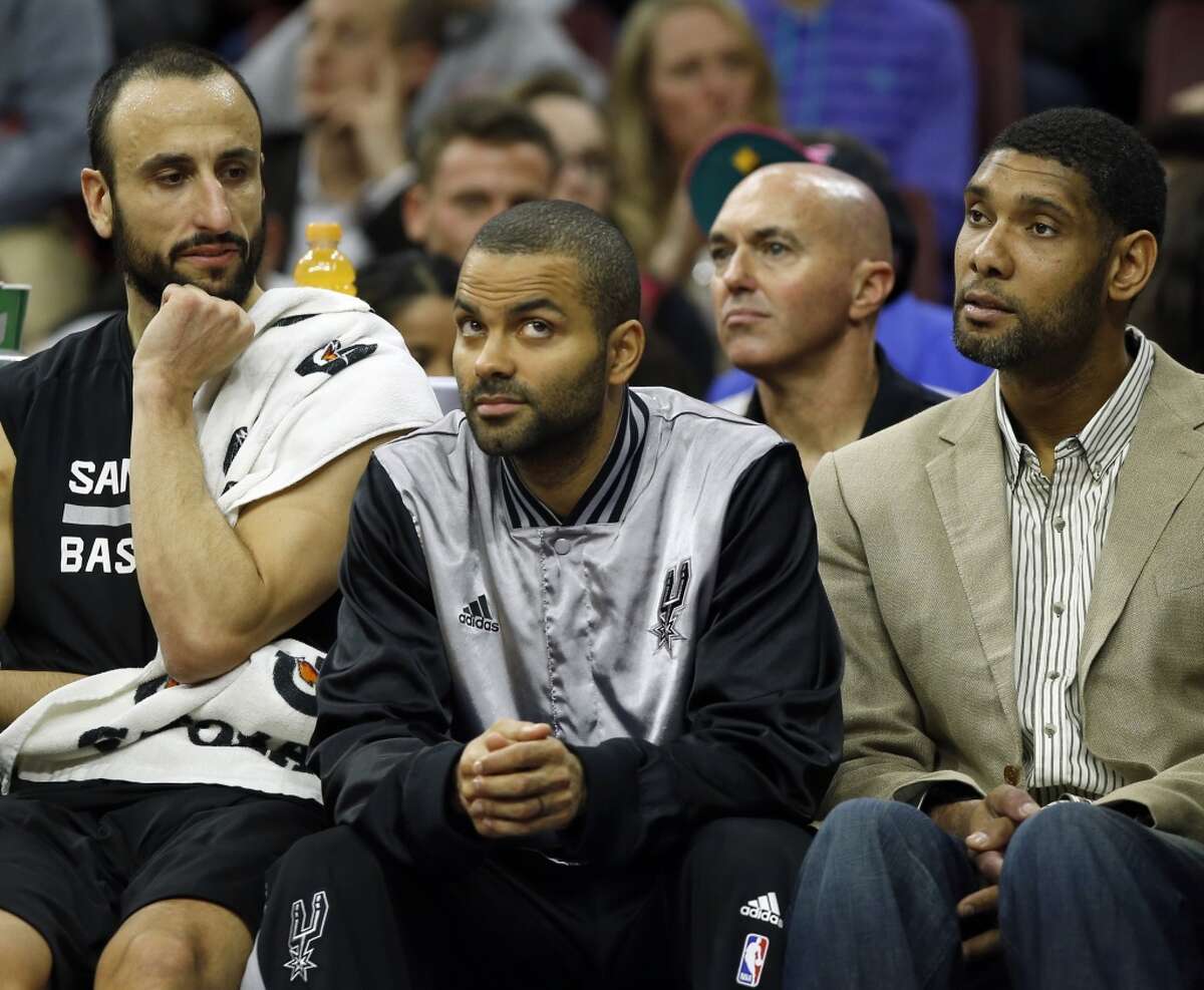 San Antonio Spurs' Manu Ginobili, Tony Parker and Tim Duncan sit on the Spurs bench against the Philadelphia 76ers on Monday, Dec. 1, 2014, at Wells Fargo Center in Philadelphia. Parker and Duncan did not play during the first half. (Yong Kim/Philadelphia Inquirer/TNS)