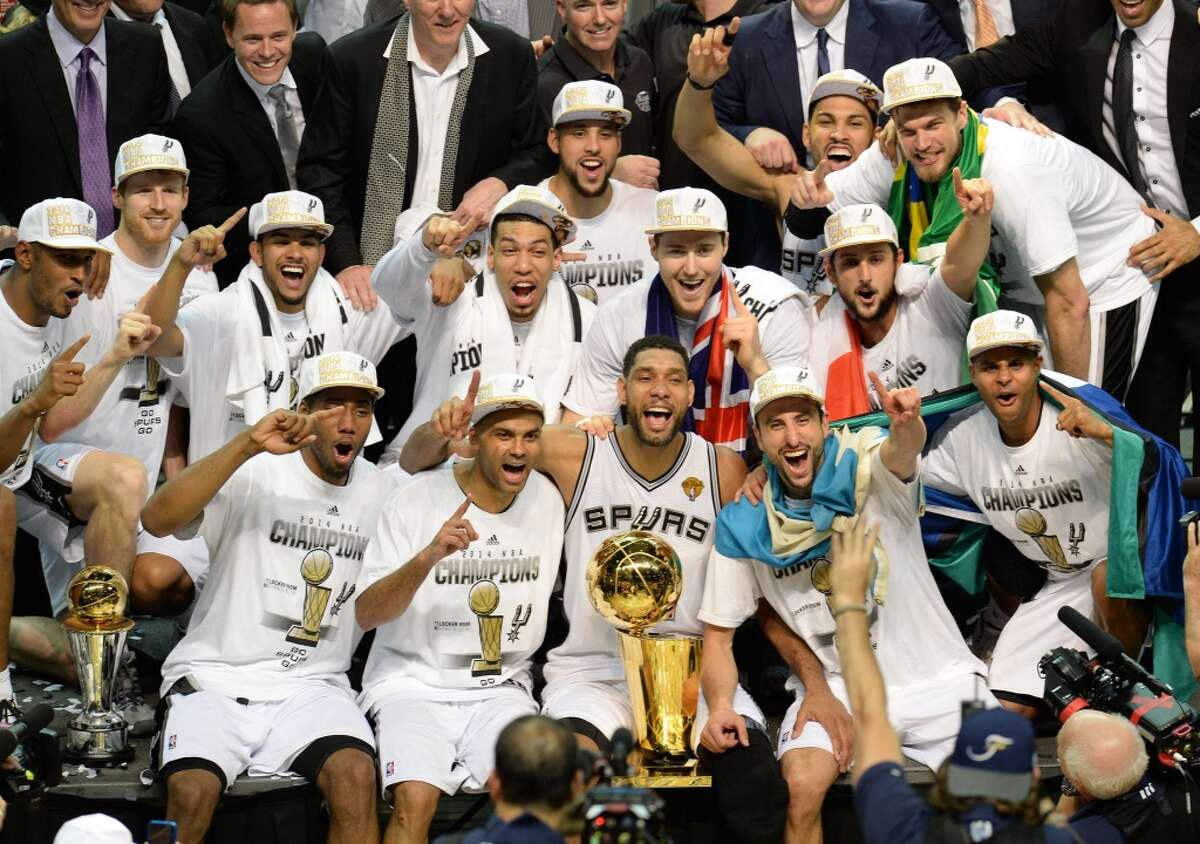 This June 15, 2014 file photo shows the San Antonio Spurs as they celebrate with the Larry O'Brien NBA Championship Trophy after the Spurs defeated the Miami Heat 107-84 in Game 5 of the NBA Finals to win the NBA Finals Championship, in San Antonio,Texas. AFP PHOTO / Robyn BeckROBYN BECK/AFP/Getty Images