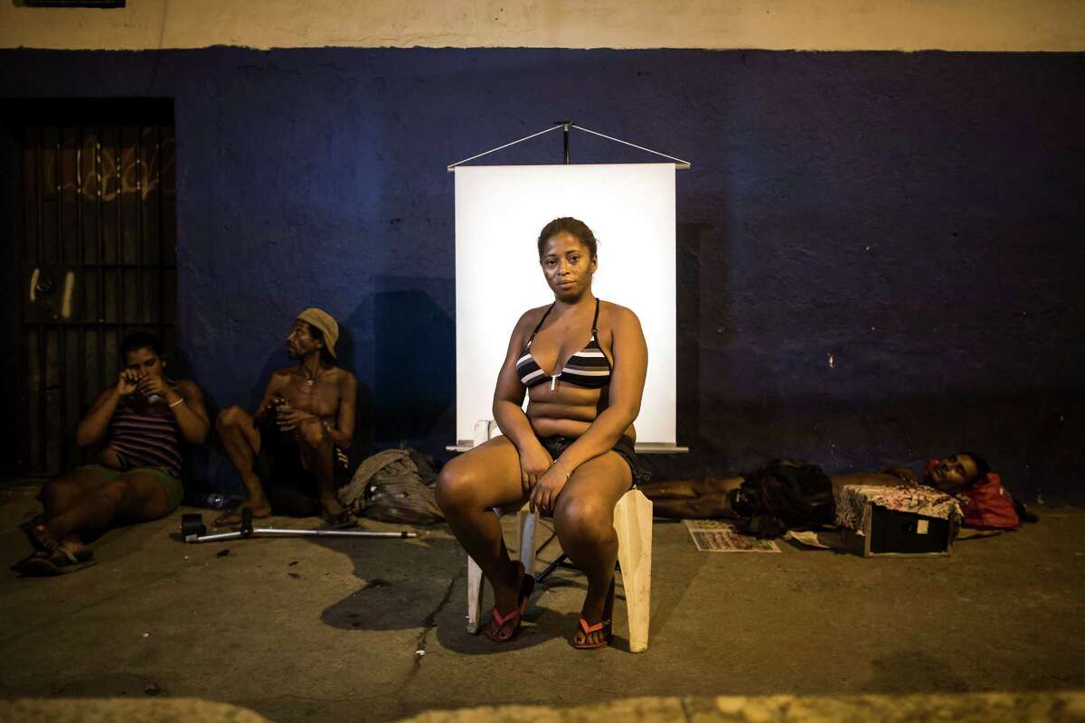 In this March 14, 2015 photo, Valeria de Brito, 36, poses for a portrait in an open-air crack cocaine market, known as a “cracolandia” or crackland where users can buy crack, and smoke it in plain sight, day or night, in Rio de Janeiro, Brazil. Brito, who has been using crack for over 8 years says she does not like the crackland environment, that she prefers to use drugs elsewhere. (AP Photo/Felipe Dana)