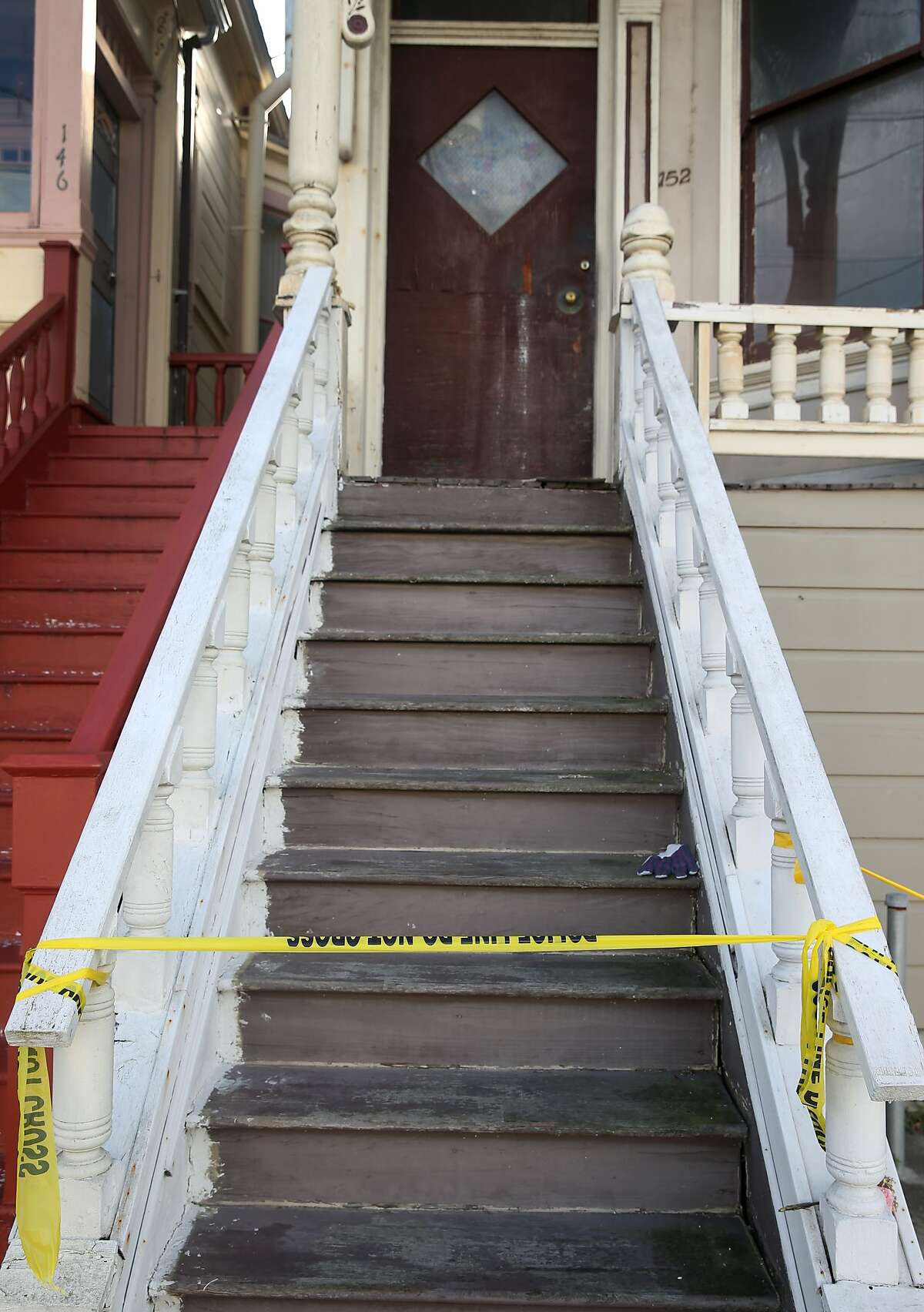 Crime scene tape remains on a stairway leading to a home on Fourth Avenue in San Francisco, Calif. on Wednesday, April 8, 2015, where a mummified body was removed over the weekend.