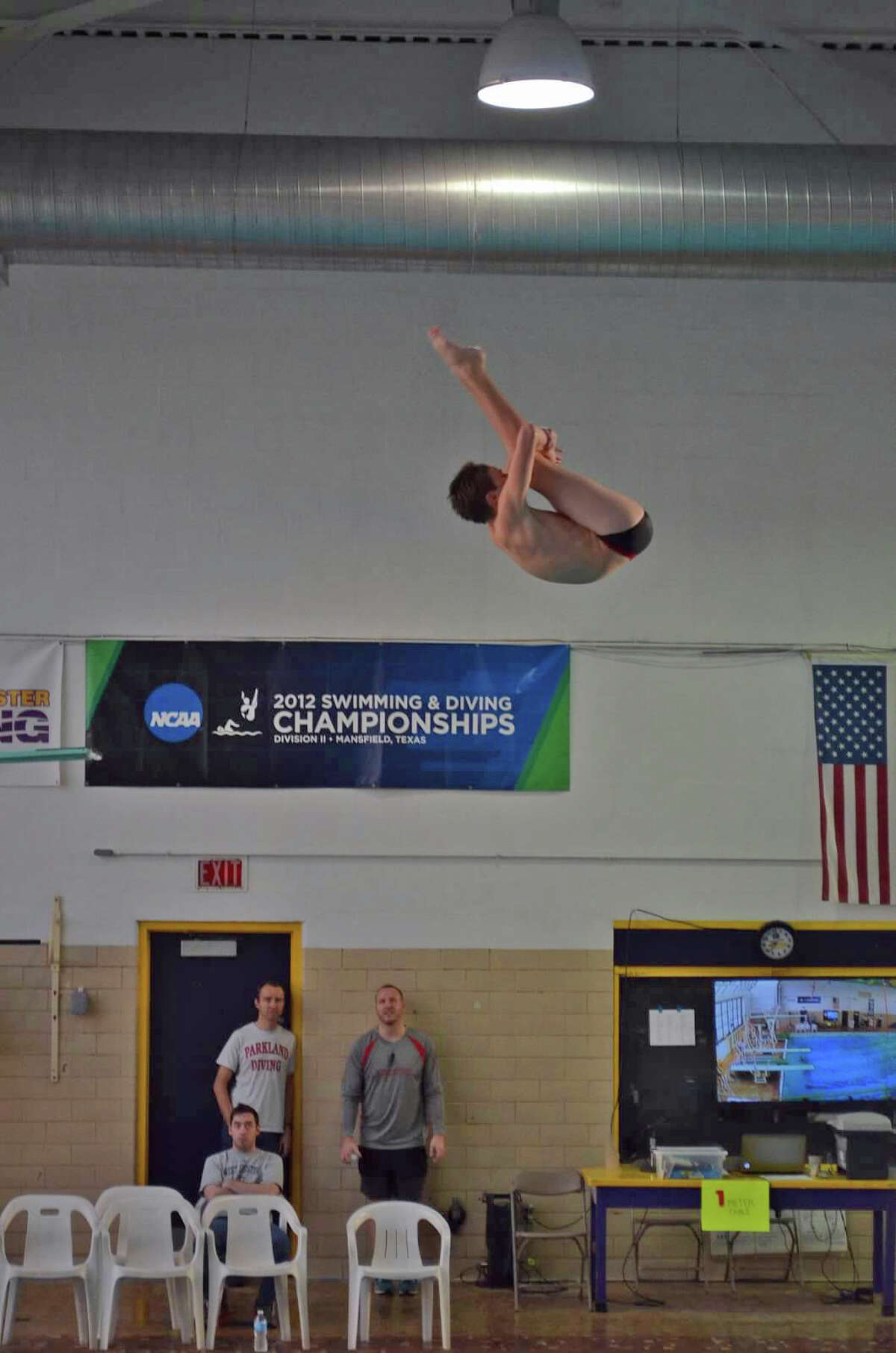 Darien's Owen Stevens holds a pike in mid air at the John Smith AAU Red White Blue National Qualifying meet in Rockville, Maryland on March 30, 2015. Stevens medaled in all four events.