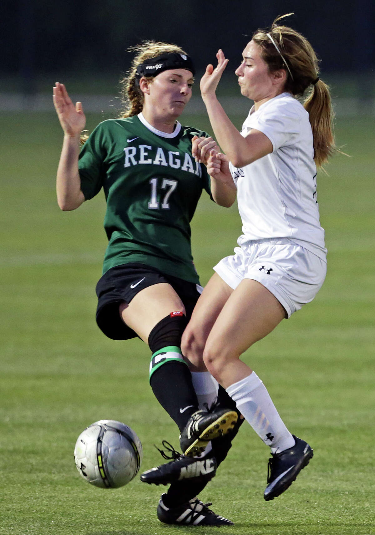 Sarah Grace Freeman collides with the Rangers' Gabby Rodriguez (right) as the Reagan girls beat Smithson Valley 1-0 in third round 6A soccer playoffs at the UTSA Park West Complex on April 7, 2015.