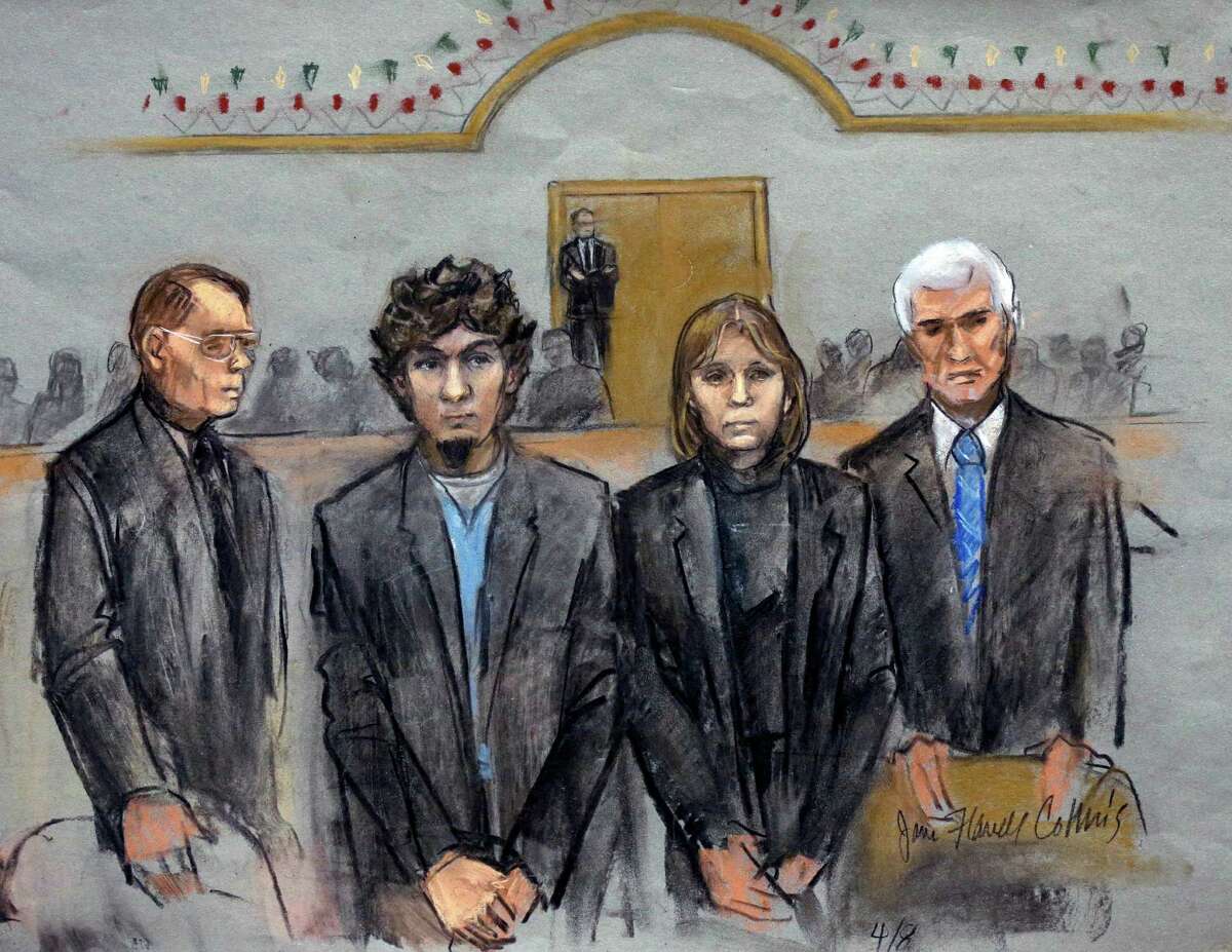 In this courtroom sketch, Dzhokhar Tsarnaev, second from left, is depicted standing with his defense attorneys William Fick, left, Judy Clarke, second from right, and David Bruck, right, as the jury presents its verdict in his federal death penalty trial Wednesday, April 8, 2015, in Boston. Tsarnaev was convicted on multiple charges in the 2013 Boston Marathon bombing. Three people were killed and more than 260 were injured when twin pressure-cooker bombs exploded near the finish line. (AP Photo/Jane Flavell Collins) ORG XMIT: BX106