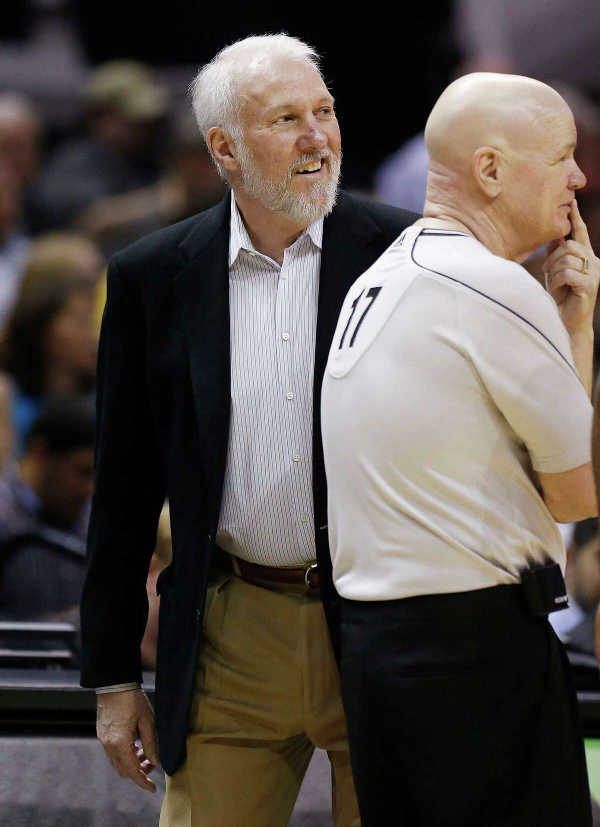 Spurs coach Gregg Popovich smiles beside official Joey Crawford (17) during the game against the Houston Rockets at the AT&T Center on Wednesday, Apr. 8, 2015. (Kin Man Hui/San Antonio Express-News)