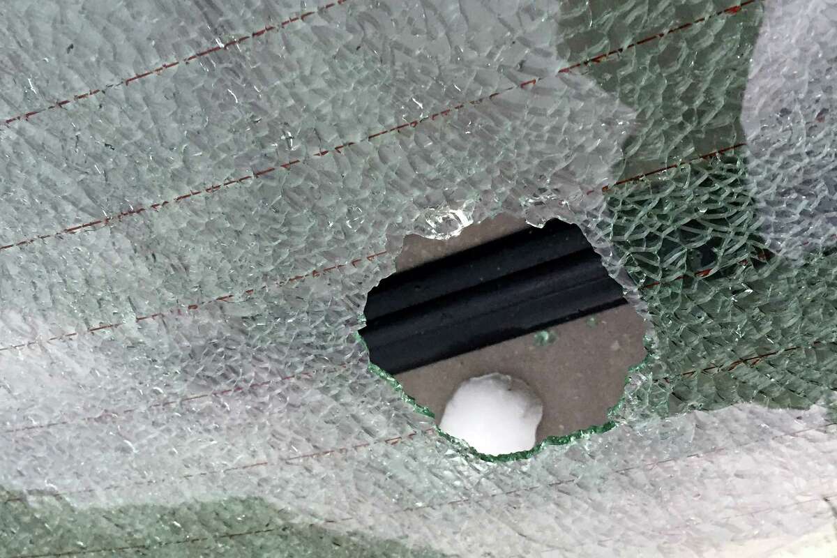 A hail stone slightly smaller than a tennis ball sits on the rear deck of a car after it smashed the rear window of the car in downtown Farmington on Wednesday, April 8, 2015. Numerous cars sustained broken windows from the hail. EDWARDSVILLE INTELLIGENCER OUT, THE ALTON TELEGRAPH OUT